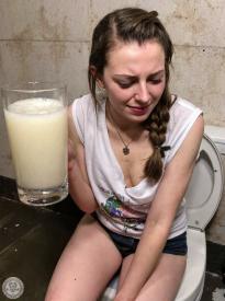 Ai image, look at her missing fingers to hold the glass, also proportions of the toilet lid is off