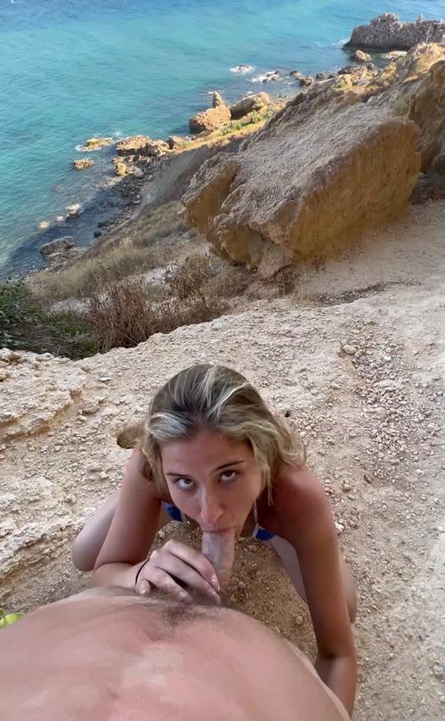 Whos this girl blowing at the beach?